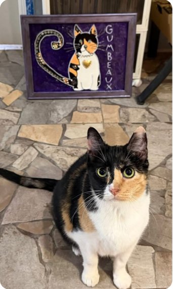Queen Gumbeaux sitting in front of her portrait